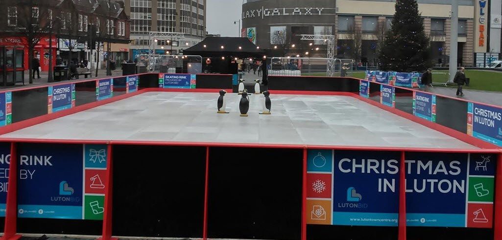 What is a synthetic ice rink surface made of